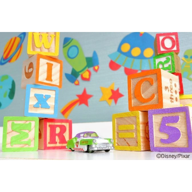  Toy Story blocks with a toy car. Blocks show letters and numbers. Space-themed background.