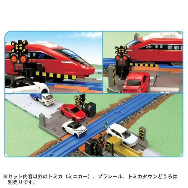  Toy train set with a red train, cars, and a railroad crossing with barriers.