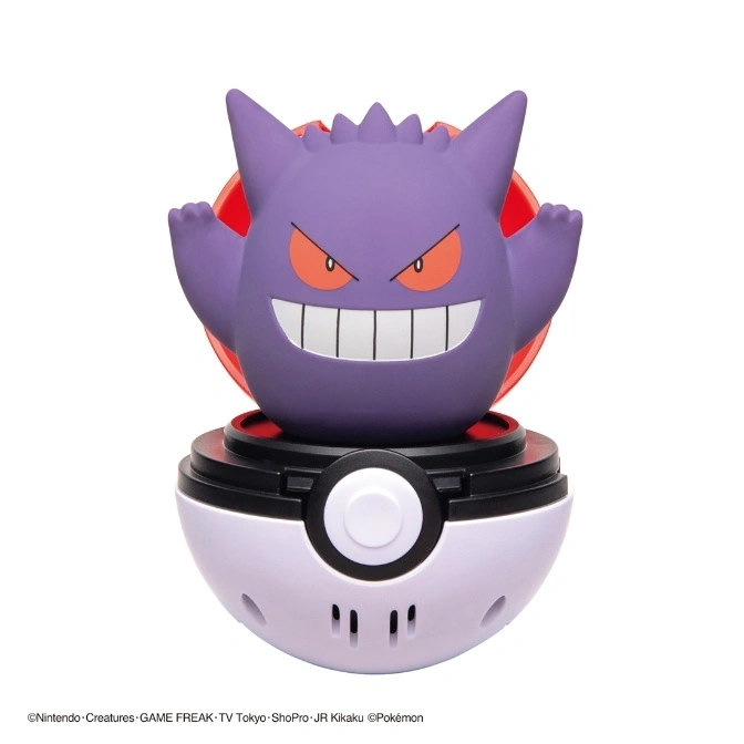 Gengar figure emerging from a Poké Ball toy, with a menacing grin and raised arms.