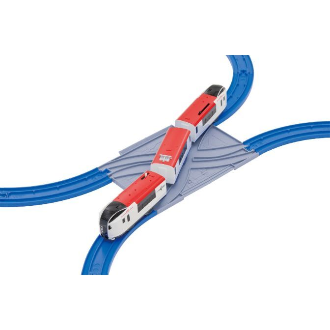  A toy train is on a blue track with a gray crossing.
