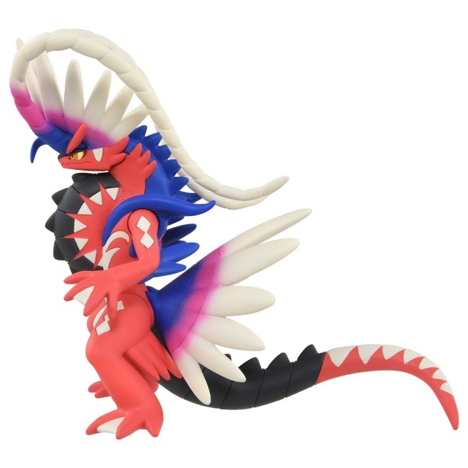 Koraidon toy figure with red body, blue accents, white feathers, and black tail.