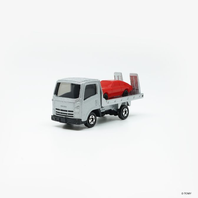  Silver Isuzu car carrier with a red car on the back.