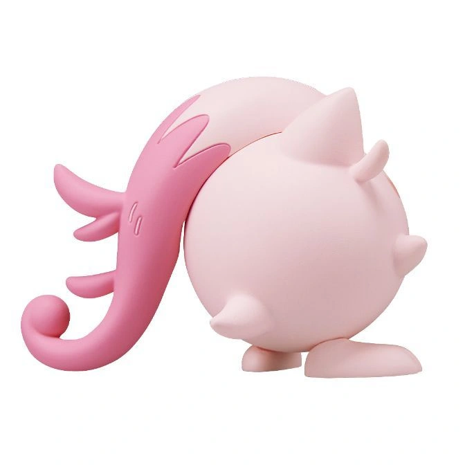  Pink Mime Jr. toy with a curled tail and small protrusions on its head, standing on a flat surface.