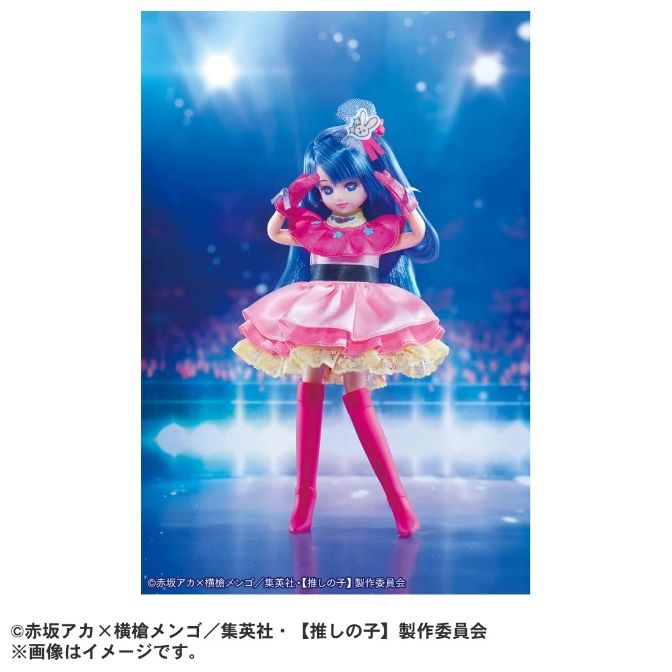  Aqua-haired doll in pink idol outfit, striking a pose on stage with spotlight background.