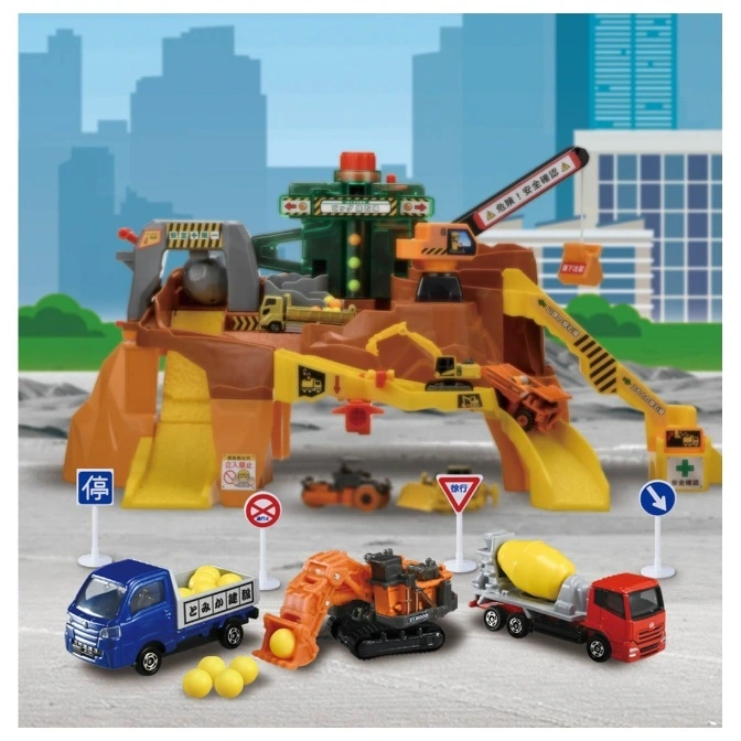  Toy construction playset with vehicles, signs, and quarry structure against a city backdrop.