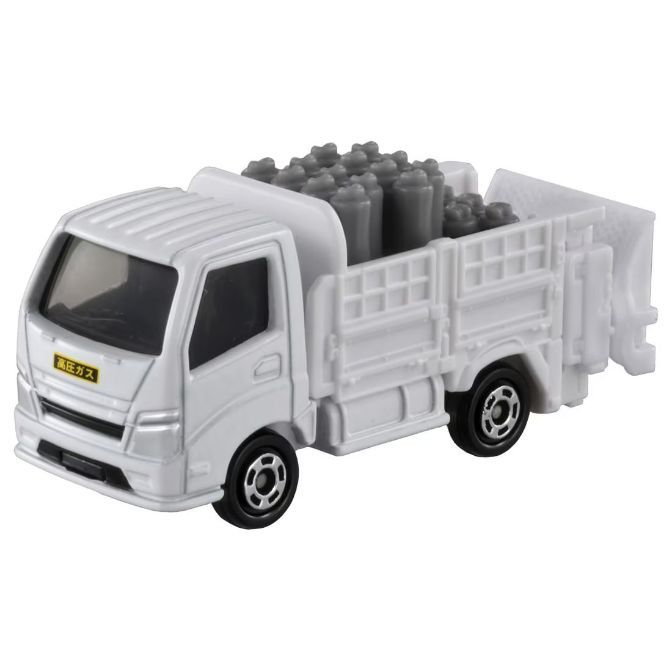 White toy truck carrying gray cylinders in its bed, with black wheels and Japanese text on the door.