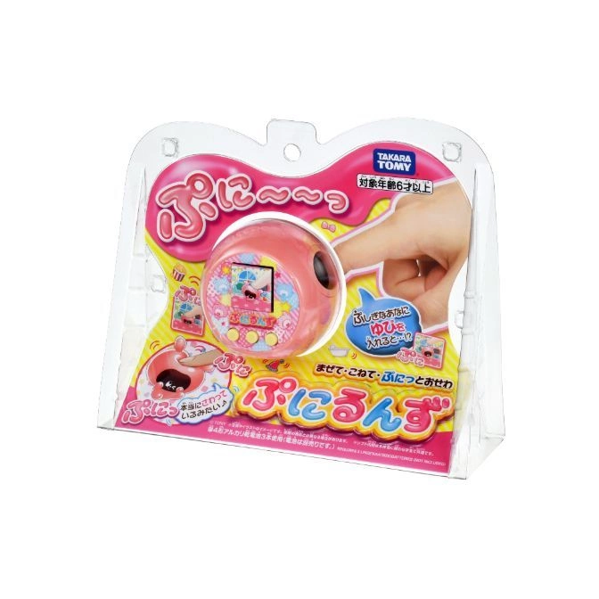  Pink Takara Tomy Punirunes virtual pet toy in packaging. Features a screen, buttons, and hand interacting with the toy.
