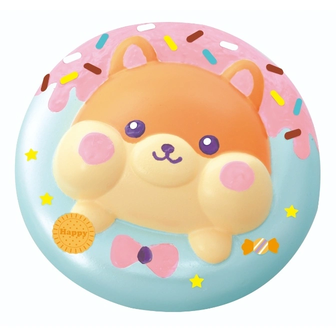 Cute dog squishy toy donut with pink frosting, sprinkles, bow, cookie, and candy.