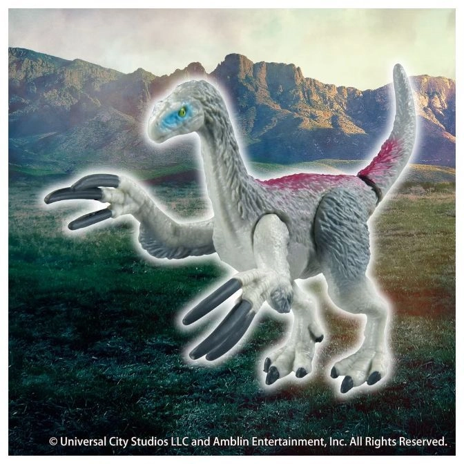  Therizinosaurus toy with long claws and blue eyes, standing against a mountain backdrop.