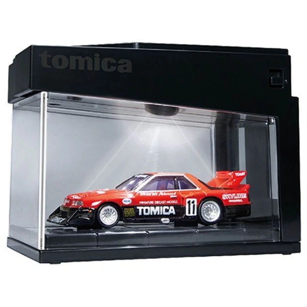 Tomica Skyline diecast car in display case with light.