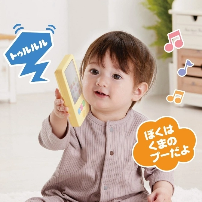  Baby holding a toy phone with sound effects and musical notes.