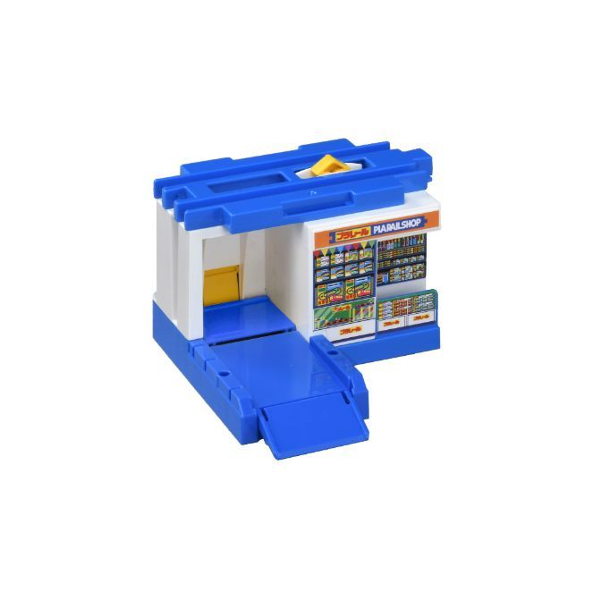 A toy train station with a blue roof and white walls.