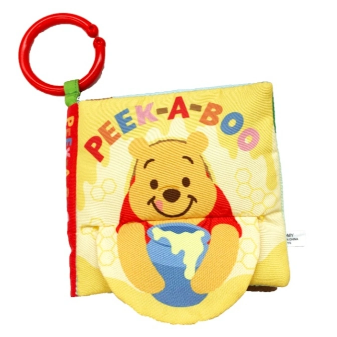Winnie the Pooh peek-a-boo soft book with a red ring for attaching to a stroller or car seat.