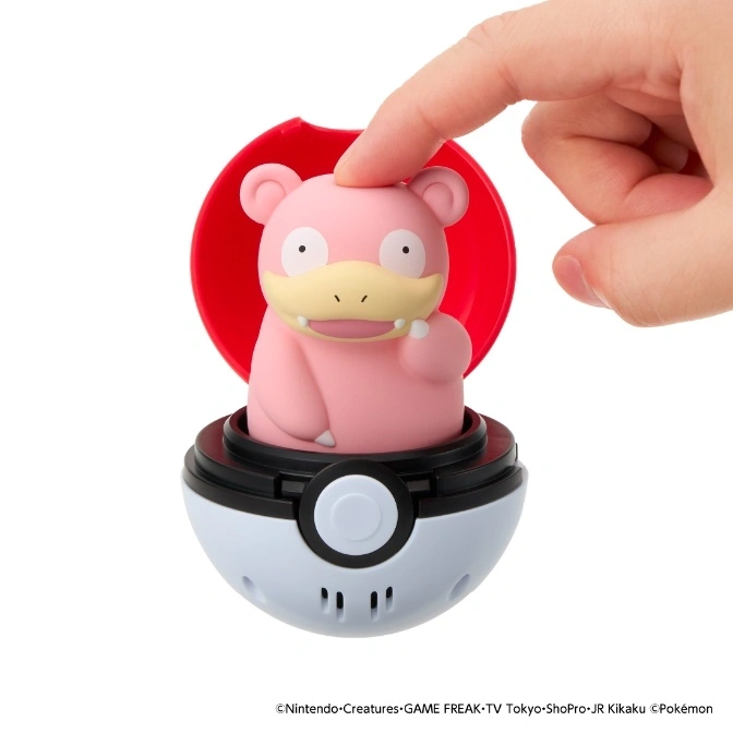  Slowpoke toy in a Poké Ball with a finger pressing its head.