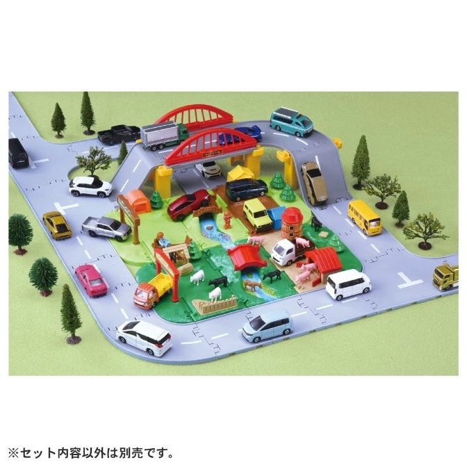  Toy farm playset with roads, bridge, vehicles, farm animals, and buildings.