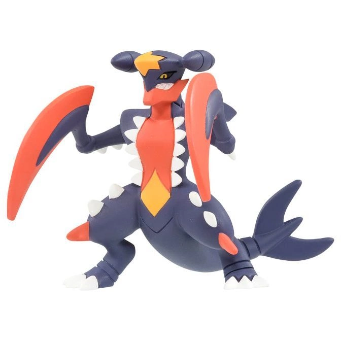 Garchomp toy figure with orange blades, dark blue body, and white spikes.