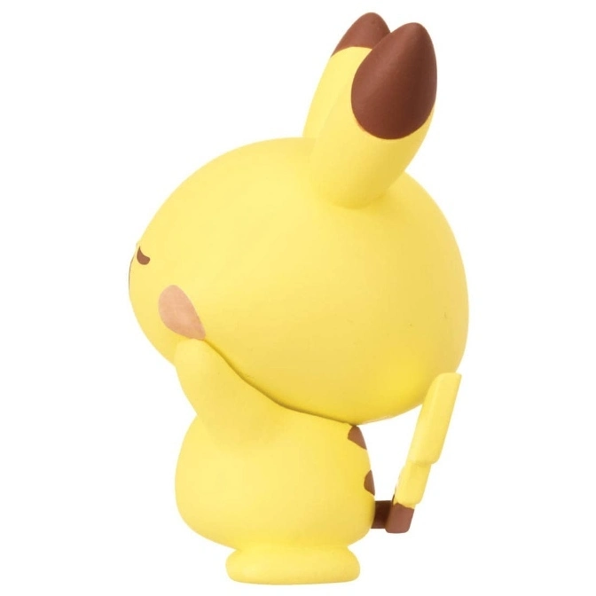  Yellow Pikachu toy figure with brown accents, cheek resting on hand.
