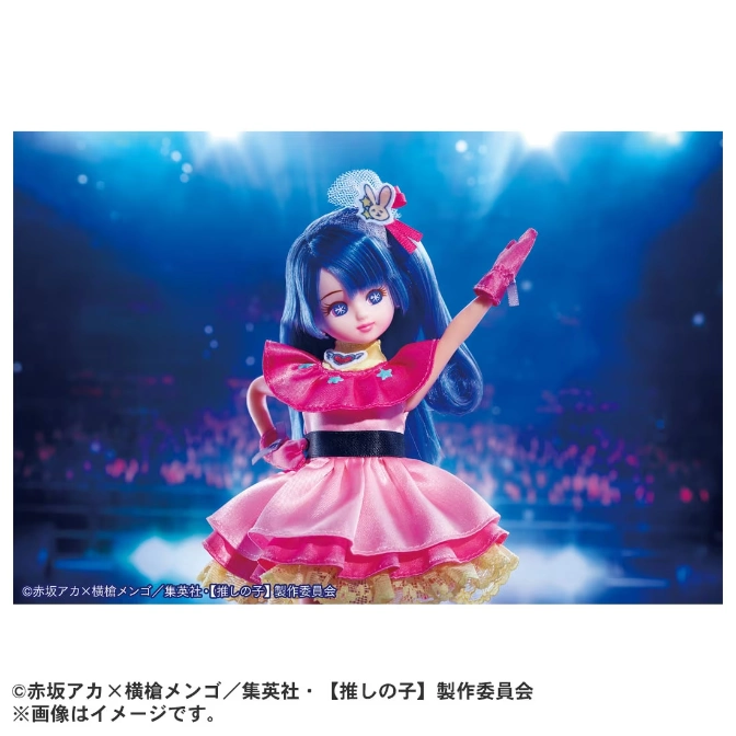  Blue-haired doll in pink idol dress, arm raised on stage.