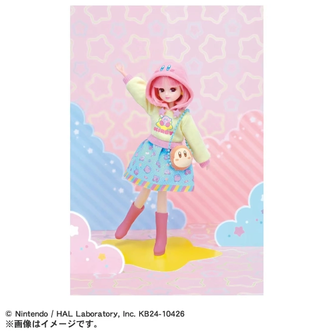  Kirby doll in pink hoodie, skirt, and boots, with Kirby purse, standing on a star-patterned platform.