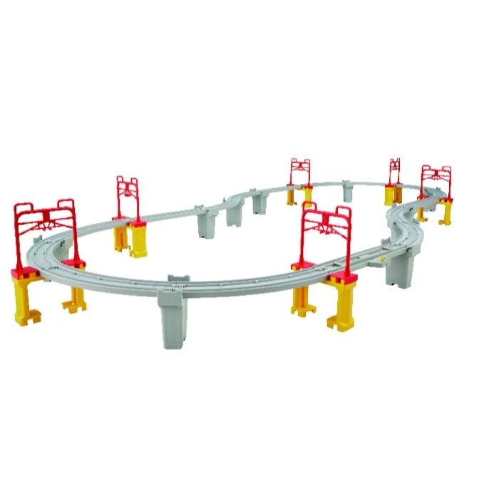 Toy train track set with gray tracks, yellow supports, and red gantries.