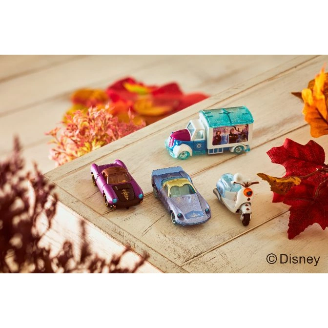  Disney Frozen toy car set featuring a truck, two cars, and a scooter on a wooden surface with fall foliage.