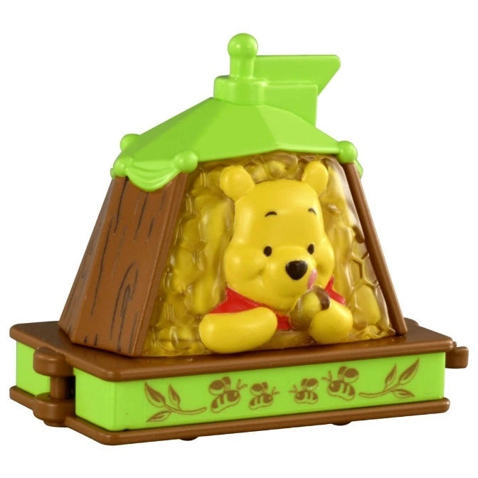 Winnie the Pooh toy in a green and brown house, holding a honey pot.