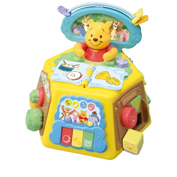Winnie the Pooh activity cube with piano keys, turning gears, and a Pooh figure.