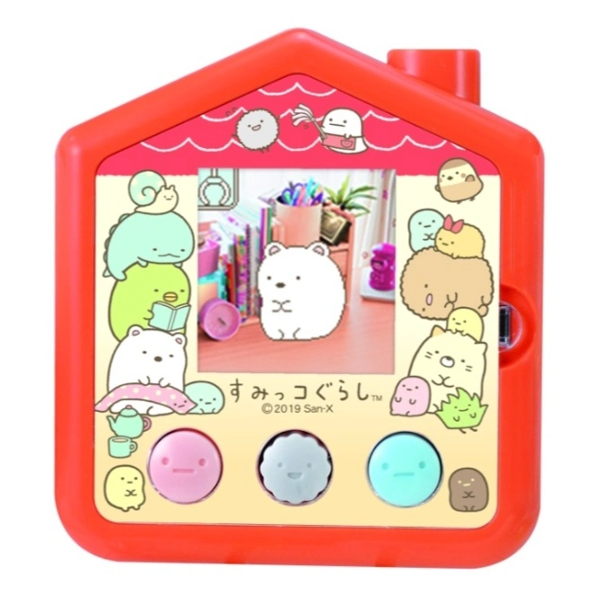 Red Sumikko Gurashi house-shaped toy with screen showing characters and buttons below.