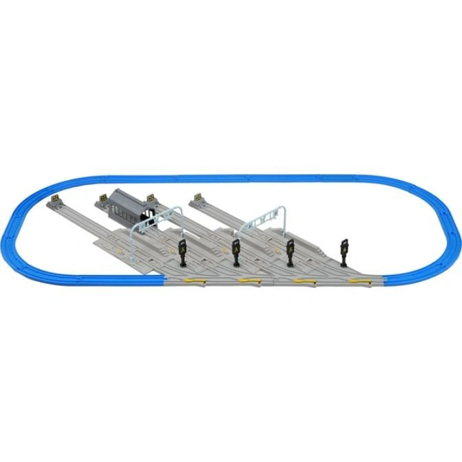 Toy train set with blue tracks, station, and signals.