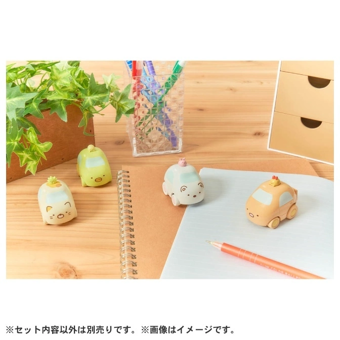  Sumikko Gurashi character car toys on a desk with stationery and a plant.