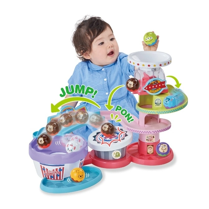  Baby playing with a Disney ball drop toy featuring Mickey Mouse and friends.