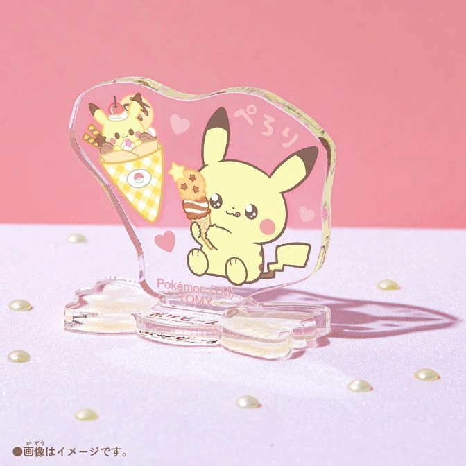  Pikachu acrylic standee with ice cream, on a pink surface with pearl beads.