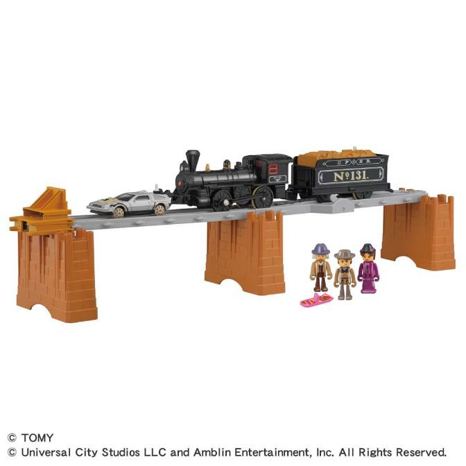 A toy train set featuring a train, a car, and three figures.
