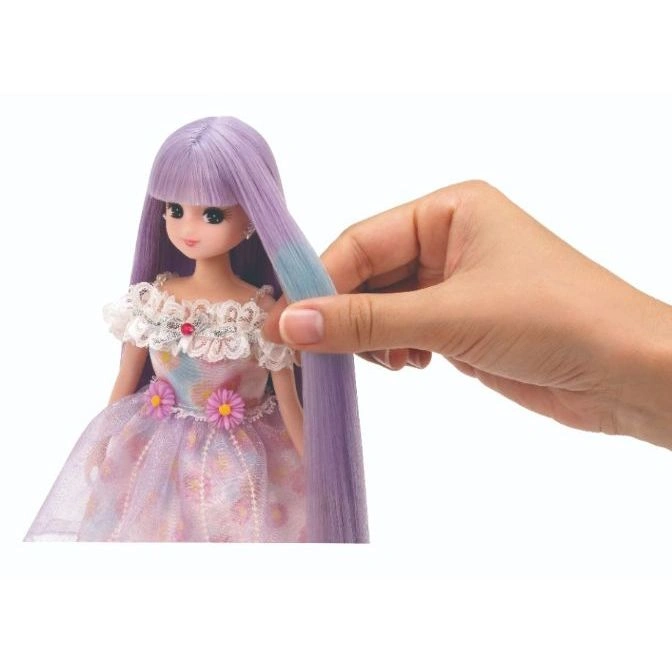  Doll with purple hair being styled by a hand, wearing a floral dress.