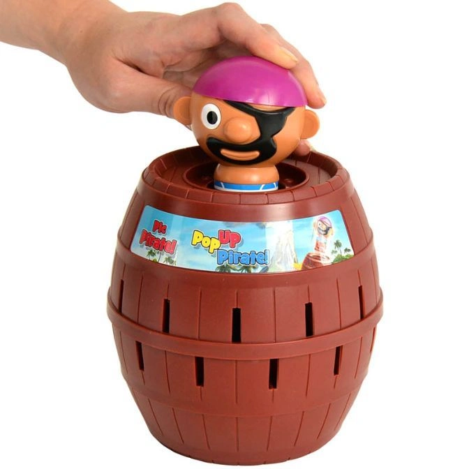  Pop-Up Pirate game with hand pressing pirate into barrel.