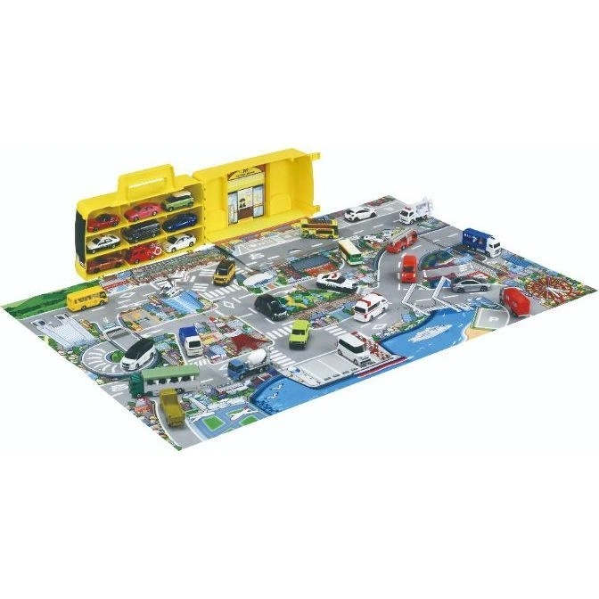  Toy city playset with cars, buses, trucks, and buildings on a playmat with roads and city scenes.