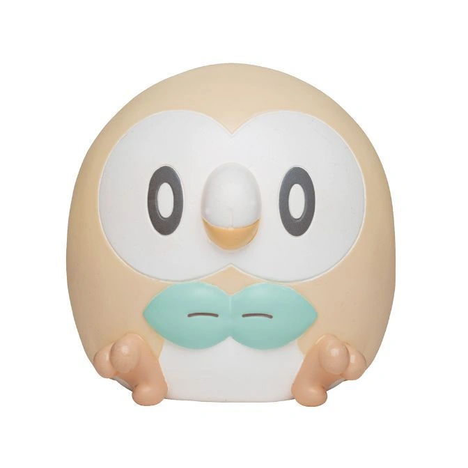 Rowlet toy with beige body, white face, and green bow tie.