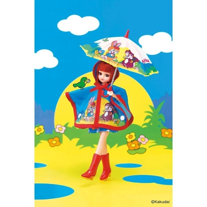  Licca doll in rain gear: blue poncho, red boots, holding a cartoon umbrella, with a green bird on her shoulder.
