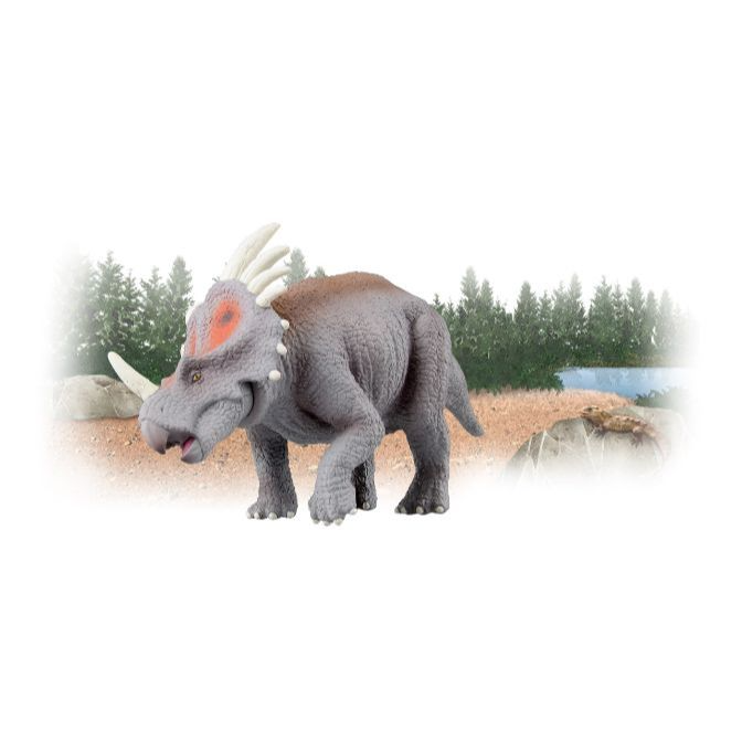  Grey toy dinosaur with horns and orange spots walking in a grassy field.