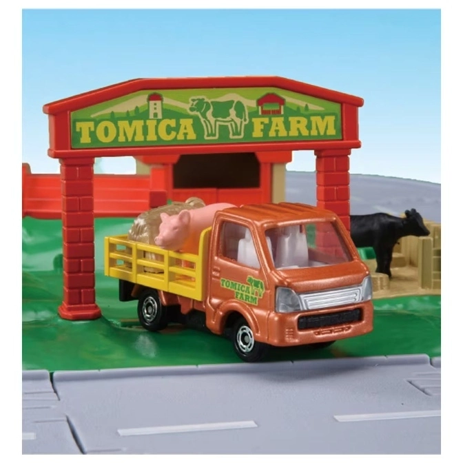  Tomica Farm playset featuring a toy truck carrying a pig, with a farm gate and cow in the background.