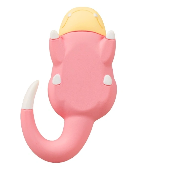  Pink Slowpoke toy lying on its back with a yellow head and curled tail.