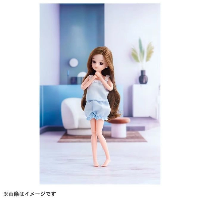  Licca-chan doll in blue pajamas, standing in a modern room.