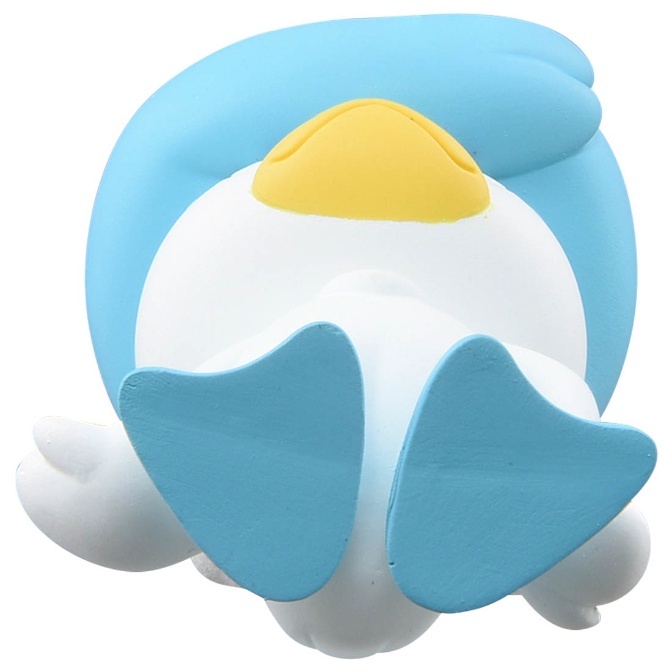 Blue and white Piplup toy lying on its back with yellow beak and blue feet.