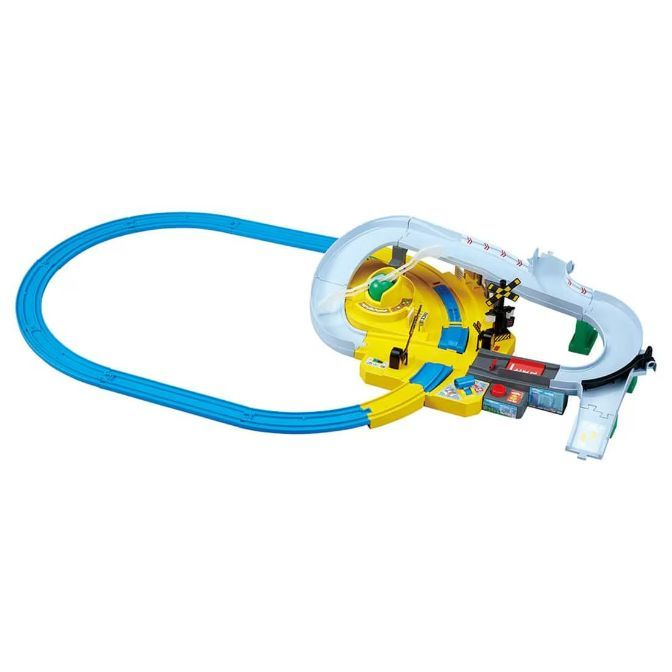 A toy train set with a blue track and a yellow and gray station.