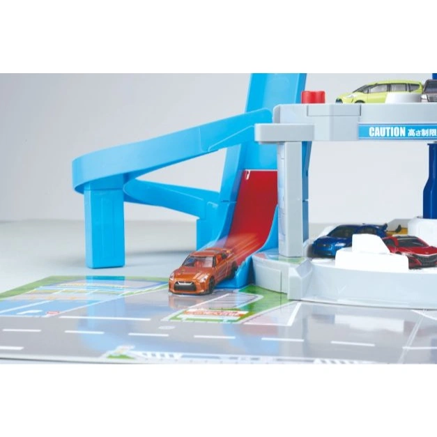  Toy car garage with ramp. Orange car speeding down, others parked. "Caution" sign visible.