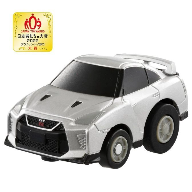 Silver toy car with large wheels and a spoiler. It has a Japan Toy Award badge.