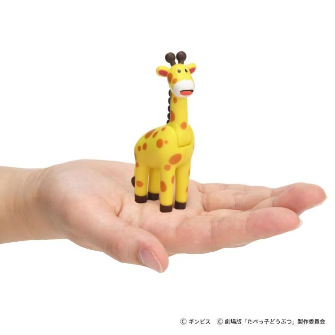  Toy giraffe with brown spots on a hand.