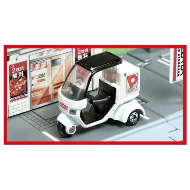 Pizza-La delivery tricycle toy with black roof and white body, parked on a toy street.