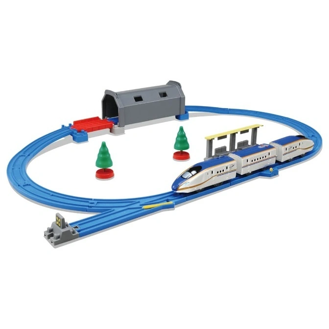 Toy train set with blue tracks, tunnel, trees, station, and a white and blue bullet train.