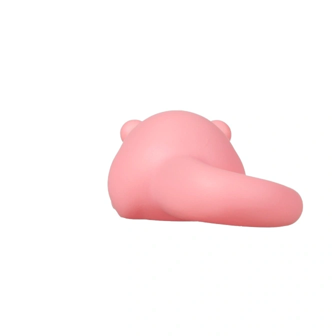  Pink bear-shaped squeaky toy with a tail, lying on its side.